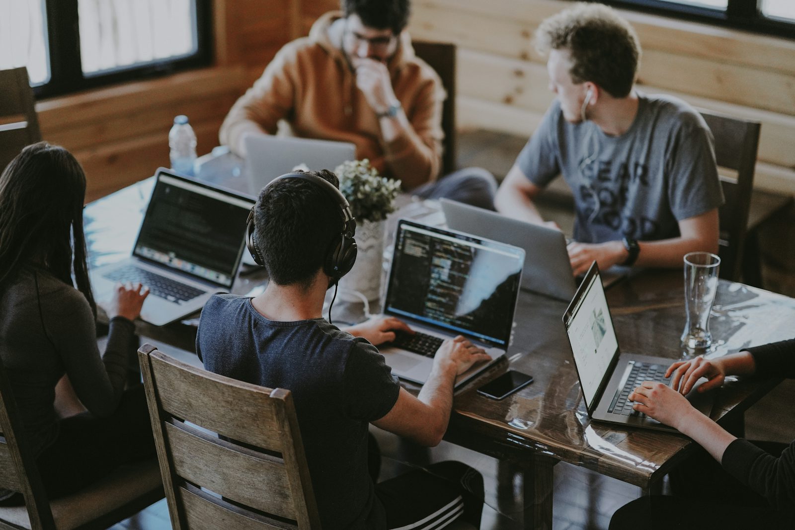 Software development team collaborating around a laptop