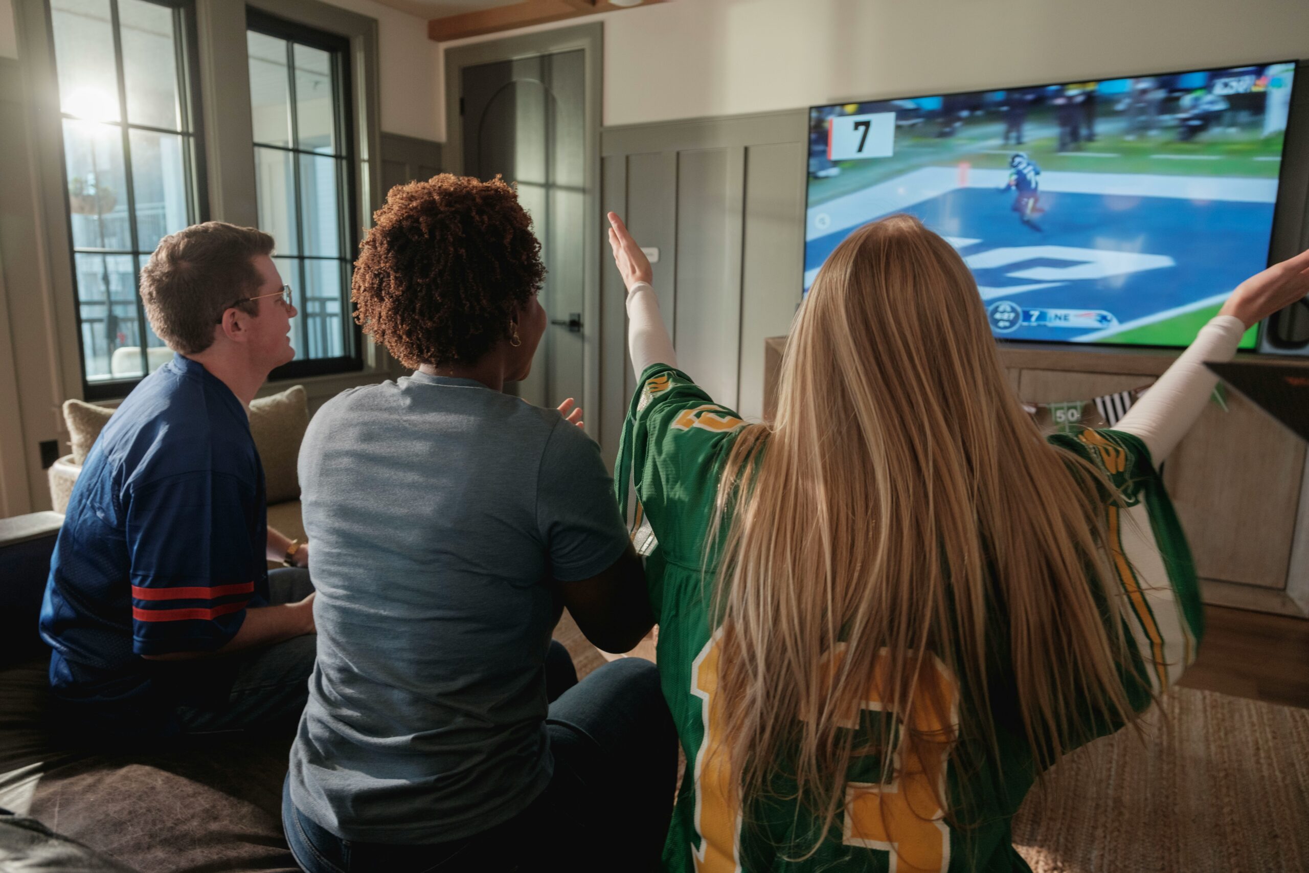 Best TVs for sports in 2026 shown in a living room watch-party setup