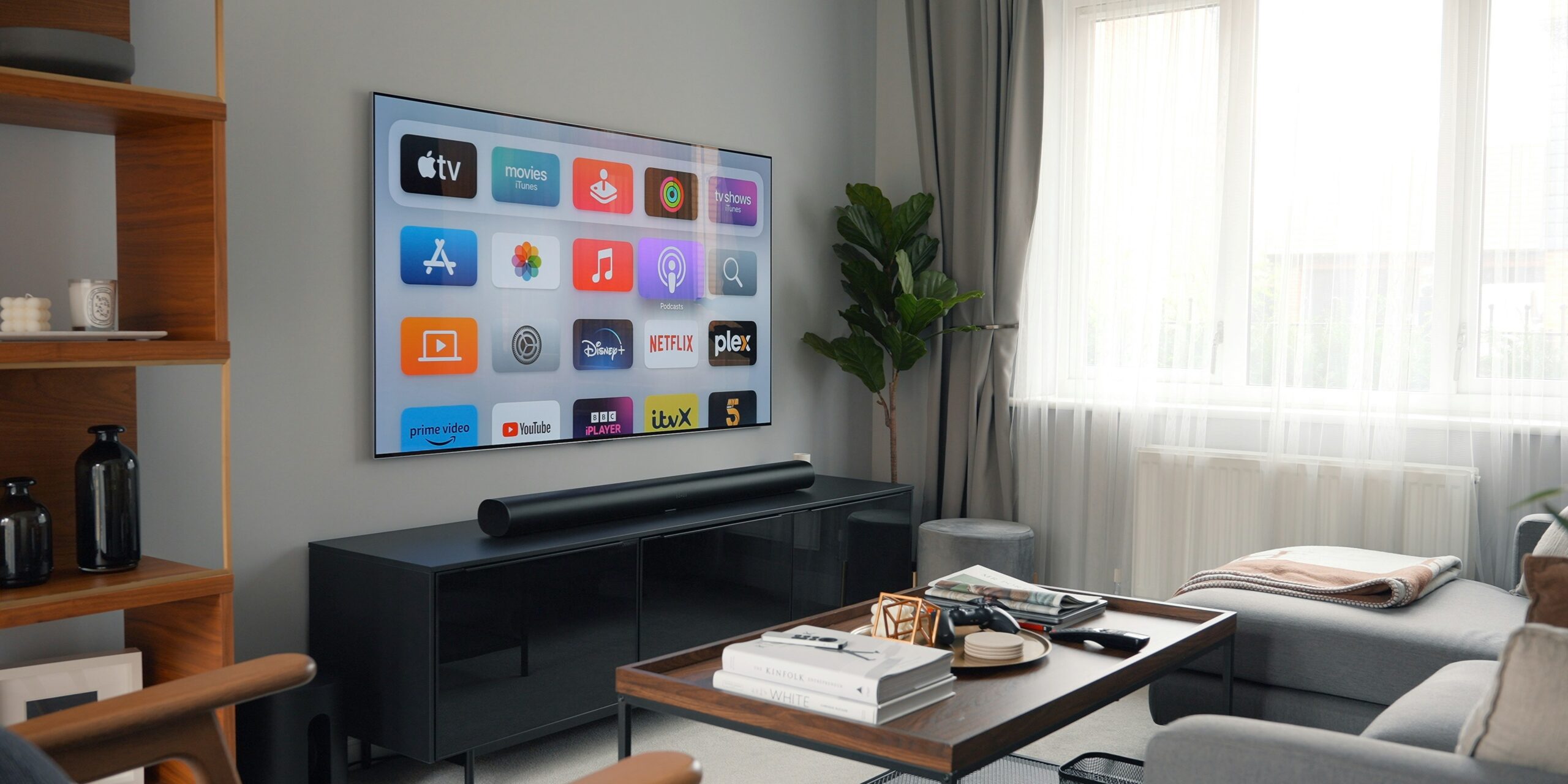 Soundbar below a television in a modern living room sports setup
