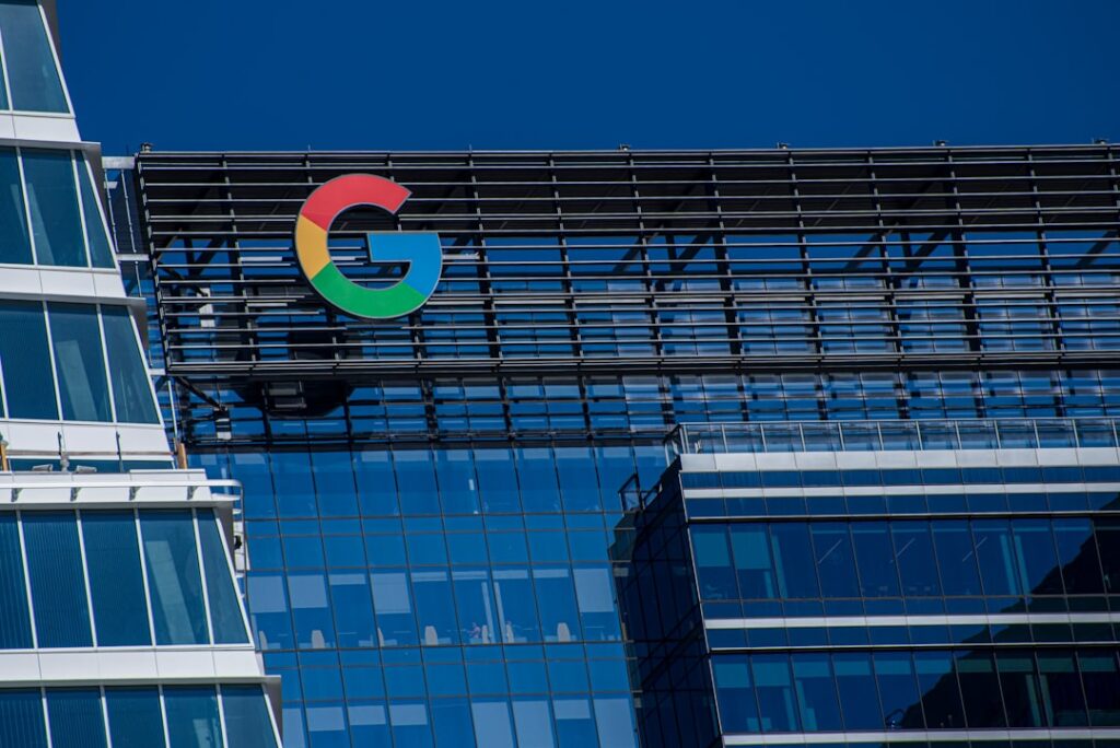 A building exterior displaying the multicolored Google logo against a clear sky