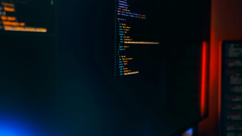 Lines of colorful code on a dark monitor, representing a terminal-based AI coding agent like Meta Muse Code