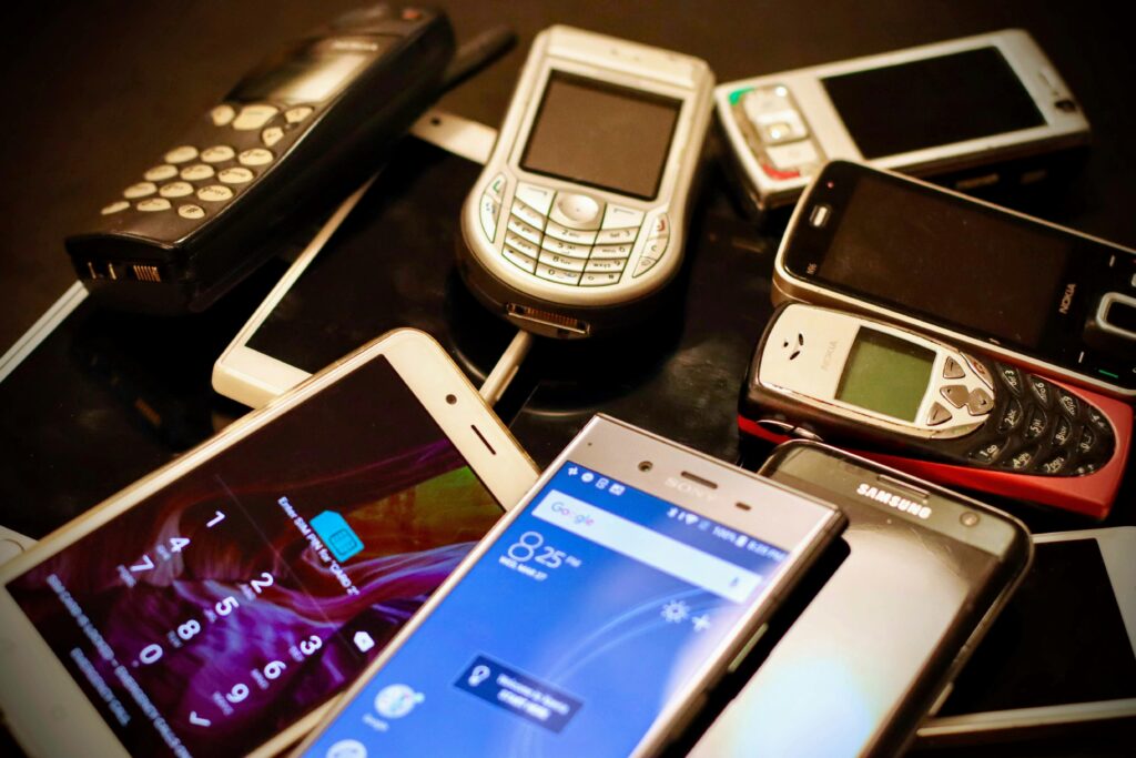 A row of smartphones from several different brands, including Nokia and Android models, laid out side by side to show how many phone makers exist