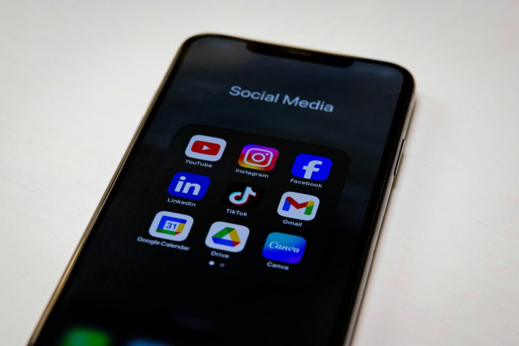 A smartphone screen showing a folder of app icons including YouTube, Gmail, Google Calendar and Google Drive, several of them made by Google.